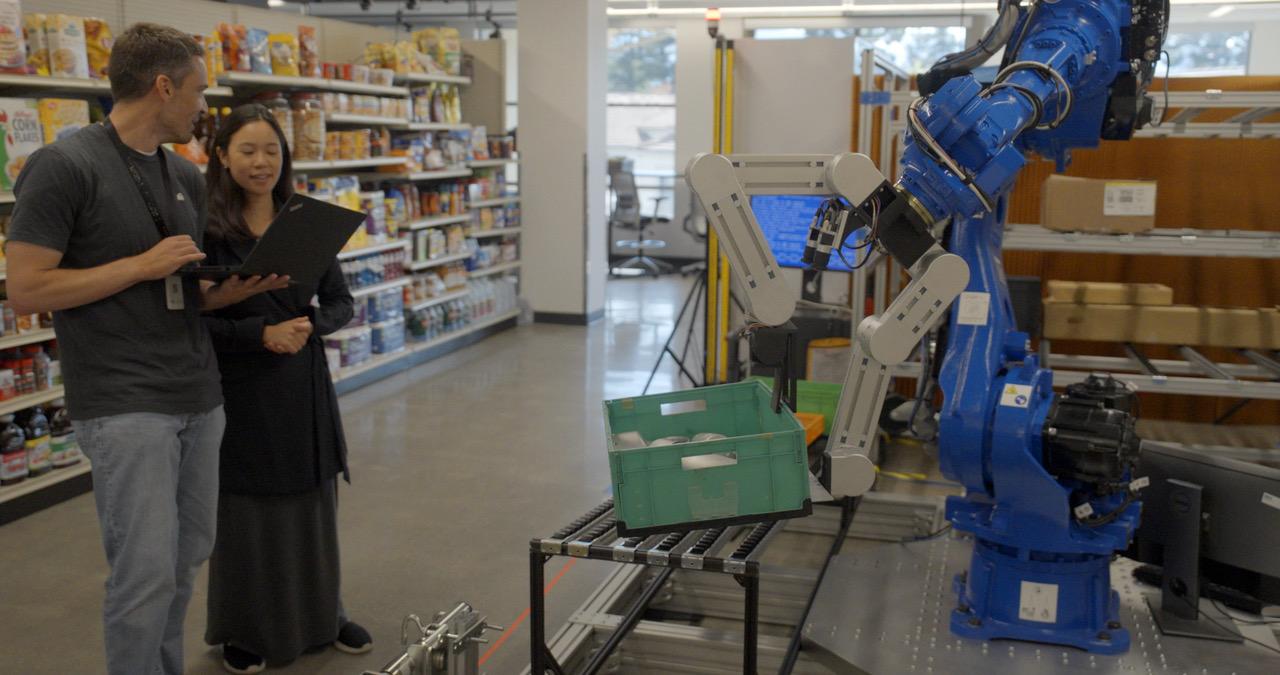 researchers with robot in mock grocery store